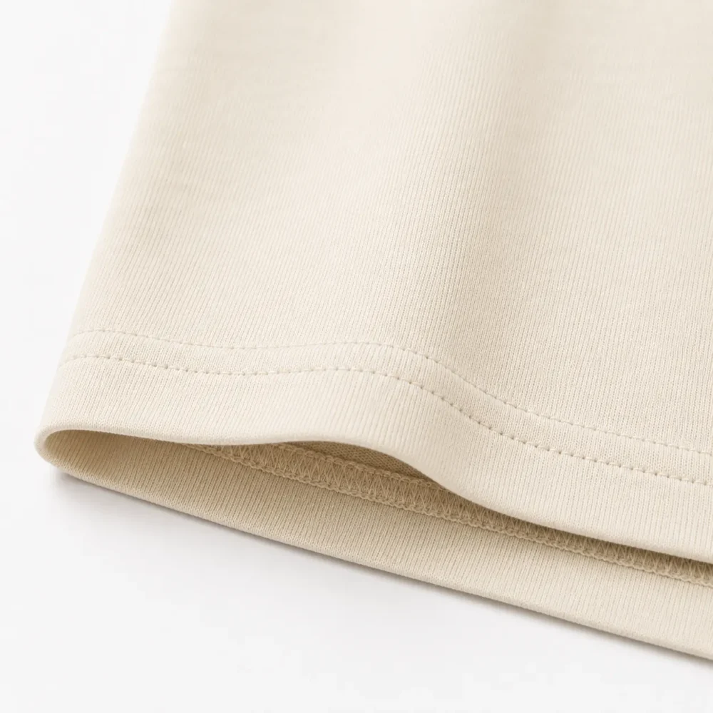 cream-heavyweight-tshirt-hem-stitching cream oversized heavyweight t shirt hem stitching close up
