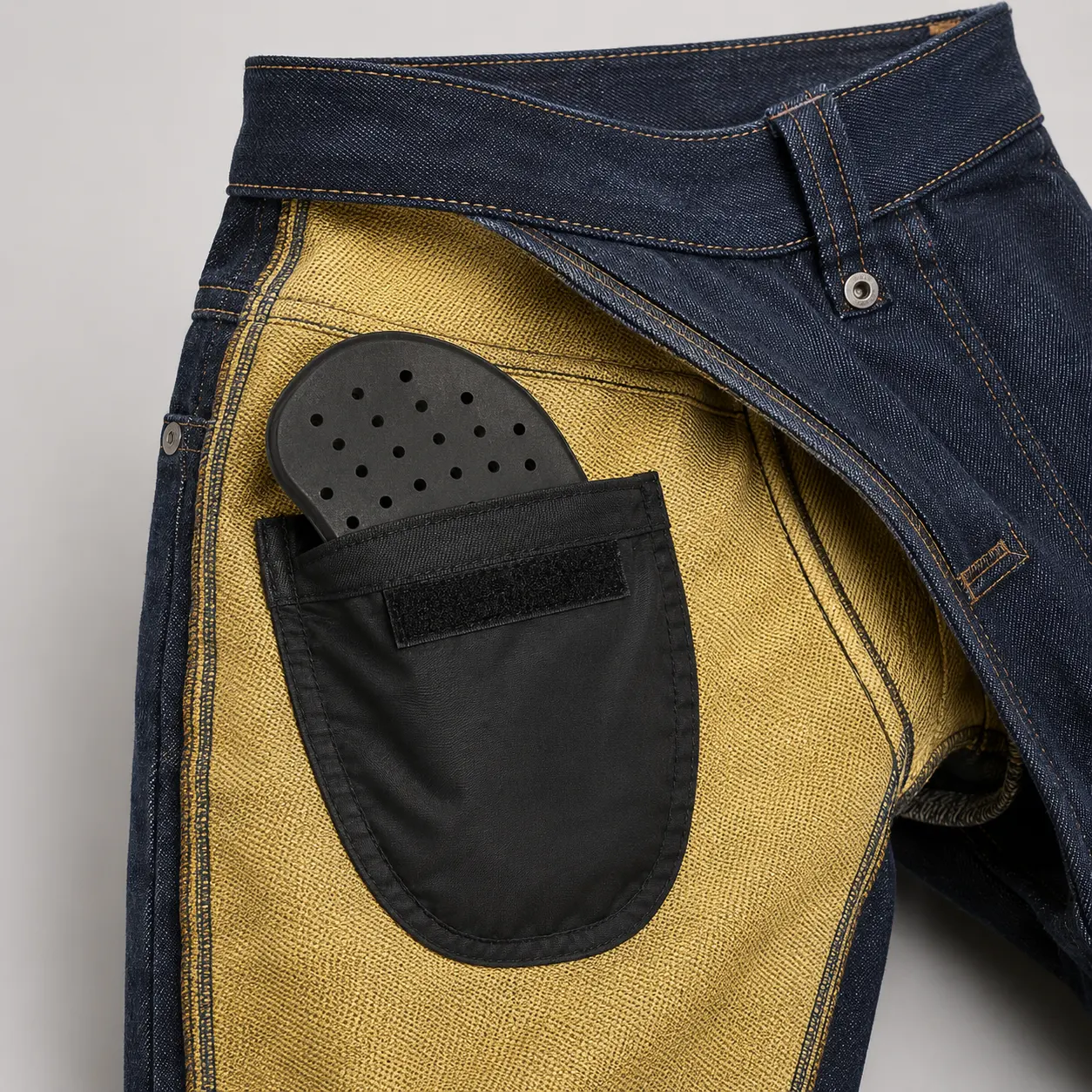 Inside view of motorcycle jeans showing a removable hip pad and internal hip pocket